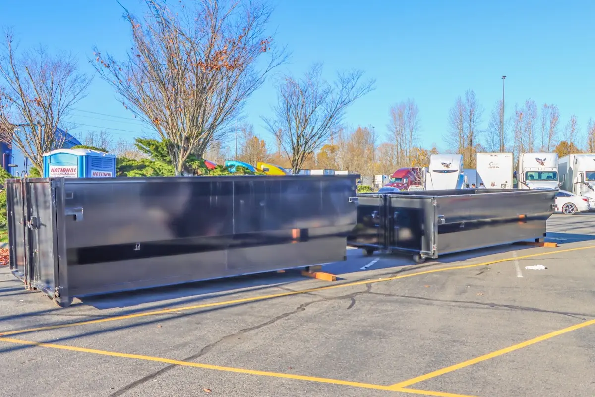 Professional dumpster rental service with roll-off container on residential driveway in Oak Bluffs